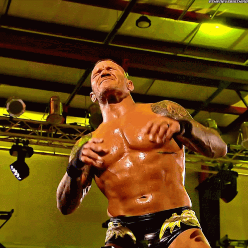 A Shirtless Wrestler With The Hashtag #Thenextbig Thing Written On The Bottom GIF
