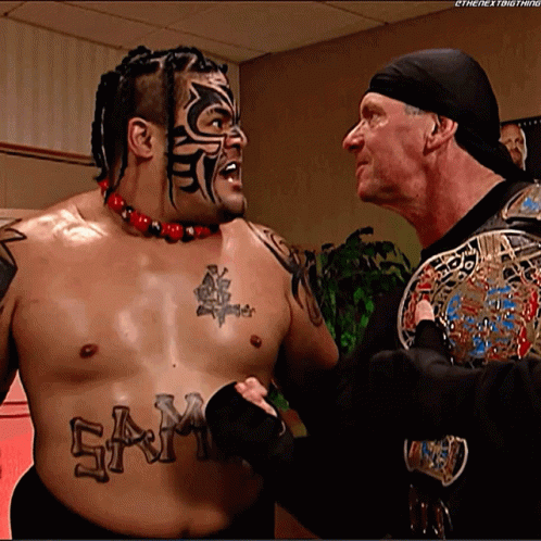 A Shirtless Wrestler With The Word Sam On His Chest GIF