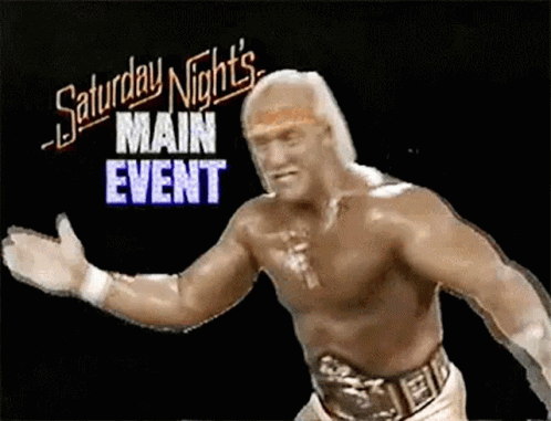 A Shirtless Wrestling Wrestler Is Standing In Front Of A Saturday Night 'S Main Event Sign . GIF