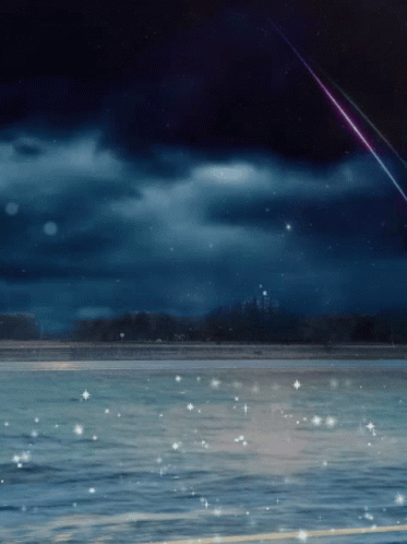 A Shooting Star Is Visible Over A Body Of Water At Night GIF
