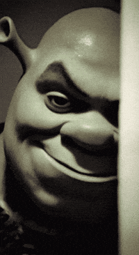 A Shrek Statue Is Smiling And Looking At The Camera GIF