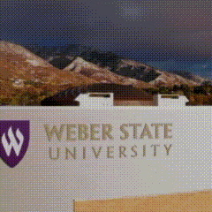 A Sign For Weber State University With A Picture Of Mountains Behind It GIF