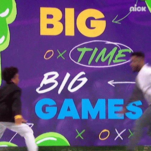 A Sign That Says Big Time Big Games With Two Men Standing In Front Of It GIF