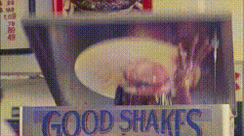 A Sign That Says Good Shakes In Blue GIF