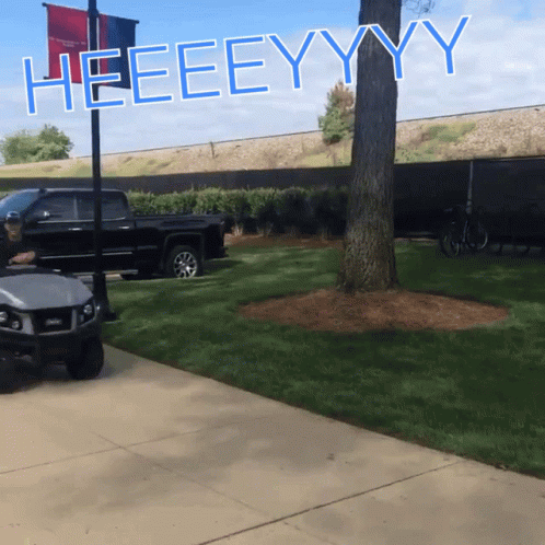 A Sign That Says Heeeeyyy Is On A Pole GIF