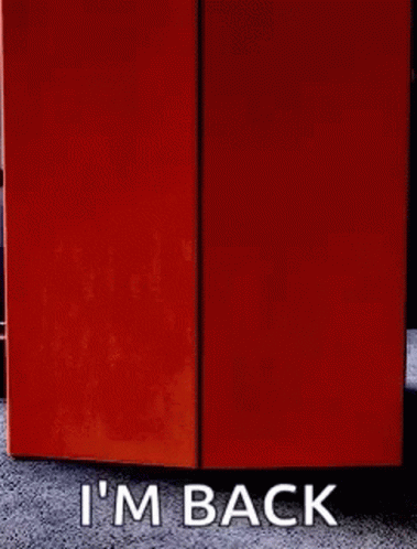 A Sign That Says I 'M Back Next To An Orange Box GIF