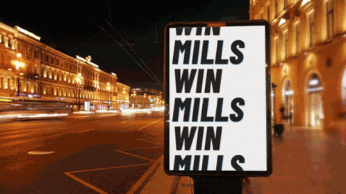 A Sign That Says " Mills Win Mills Win Mills " On It GIF