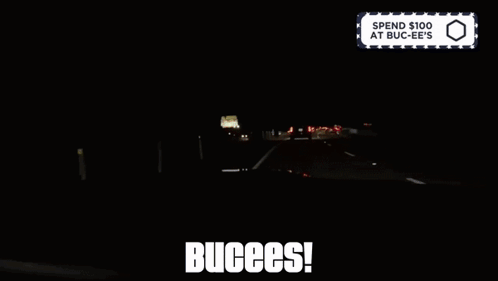 A Sign That Says Spend $ 100 At Buc-Ee 'S Is Above A Dark Highway GIF