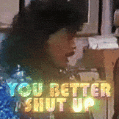 A Sign That Says " You Better Shut Up " With A Woman In The Background GIF