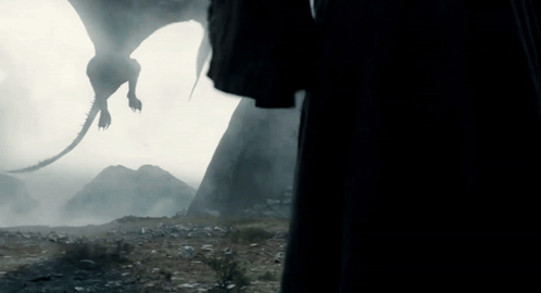 a silhouette of a dragon flying in the air