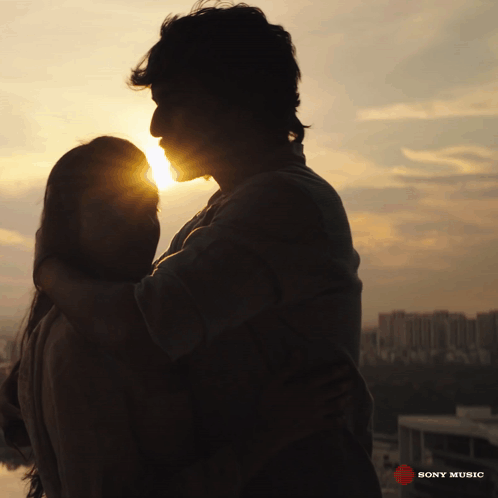 A Silhouette Of A Man And A Woman Hugging With The Words Sony Music On The Bottom GIF