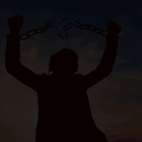 A Silhouette Of A Man Holding Chains With The Letter U Written On Them GIF