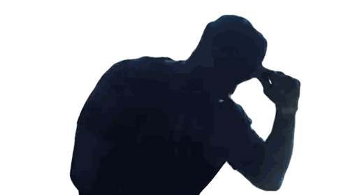 a silhouette of a man in a black shirt covering his ears