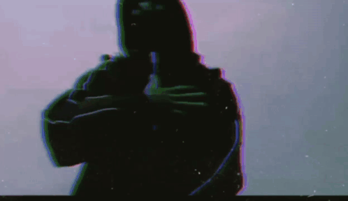 A Silhouette Of A Man In A Hooded Jacket Is Holding A Gun In His Hand . GIF