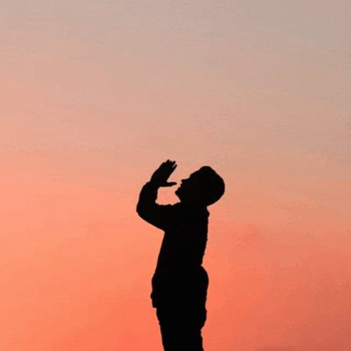A Silhouette Of A Man Praying With The Words " Prayer Changes Things " Behind Him GIF