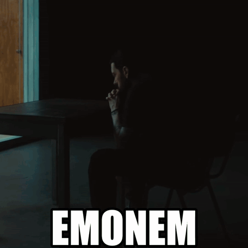 A Silhouette Of A Man Sitting At A Table With The Word Emonem Behind Him GIF