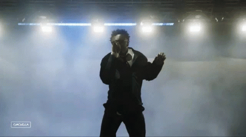 A Silhouette Of A Man Standing In Front Of A Stage With The Word Cancella On The Bottom Right GIF