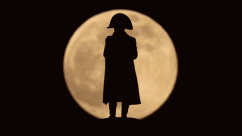 A Silhouette Of A Man With A Napoleon Hat Standing In Front Of A Full Moon GIF