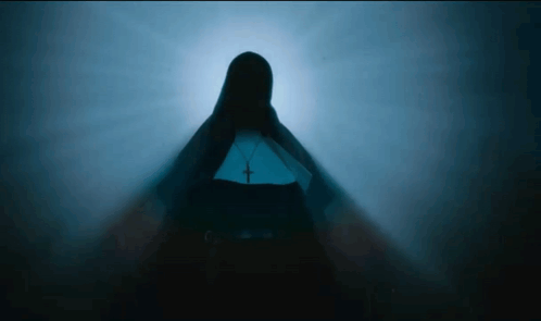 A Silhouette Of A Nun With A Cross On Her Waist GIF