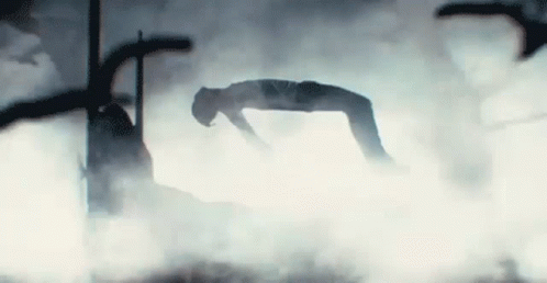 A Silhouette Of A Person Doing A Handstand In The Fog . GIF