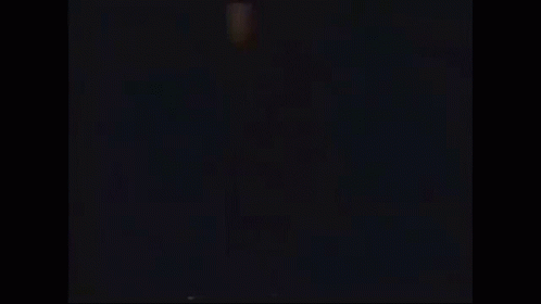 a silhouette of a person jumping in the air with their arms in the air .