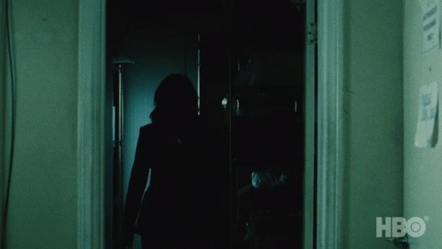 A Silhouette Of A Person Standing In A Dark Room With Hbo Written On The Wall GIF