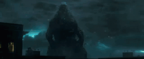 A Silhouette Of A Person Standing In Front Of A Building At Night GIF