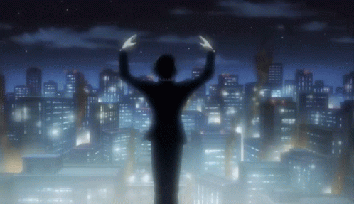 a silhouette of a person standing in front of a city at night