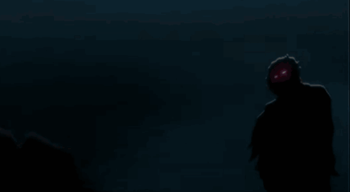 A Silhouette Of A Person Standing In The Dark With A Gray Background GIF