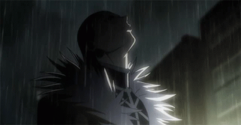 A Silhouette Of A Person Standing In The Rain With Their Eyes Closed GIF