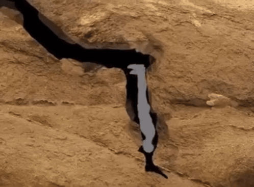 A Silhouette Of A Person Standing On A Rock GIF