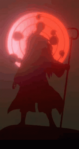 A Silhouette Of A Person With A Cane In Front Of A Red Moon GIF