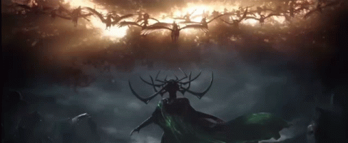 A Silhouette Of A Woman With Antlers Stands In Front Of A Cloudy Sky GIF