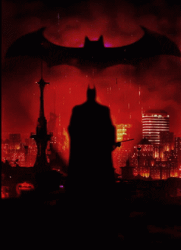 A Silhouette Of Batman Is Against A Red Background GIF