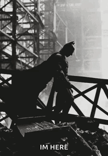 A Silhouette Of Batman Leaning On A Railing With The Words Im Here Written Below Him GIF