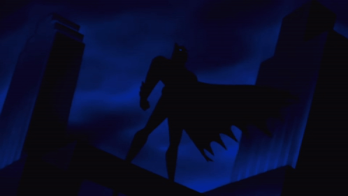 A Silhouette Of Batman Standing On A Building Roof GIF