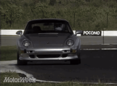 A Silver Car Is Driving On A Road With Motorweek Written On The Bottom Right GIF