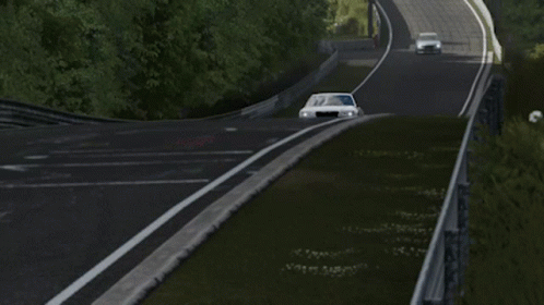 A Silver Chrysler Car Is Driving Down A Track GIF