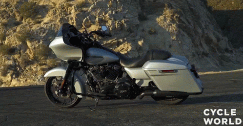a silver harley davidson motorcycle is parked on a road