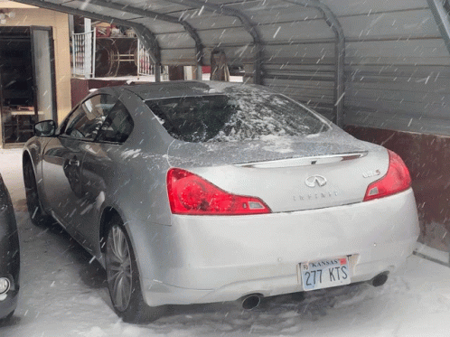 A Silver Infiniti Is Parked In The Snow And Has A Kansas License Plate GIF