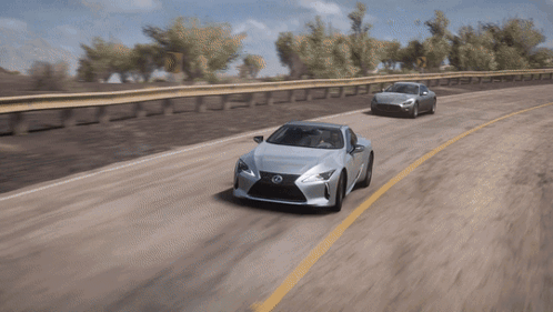 A Silver Lexus Is Driving Down A Road Next To A Silver Car GIF