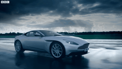 A Silver Sports Car Is Driving On A Wet Road With Bbc Written On The Bottom GIF