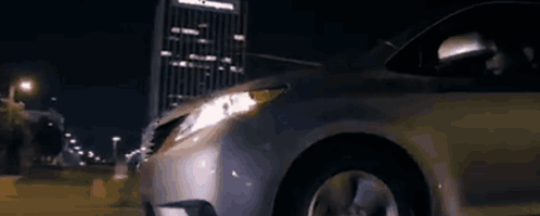 A Silver Van Is Parked In Front Of A House At Night GIF
