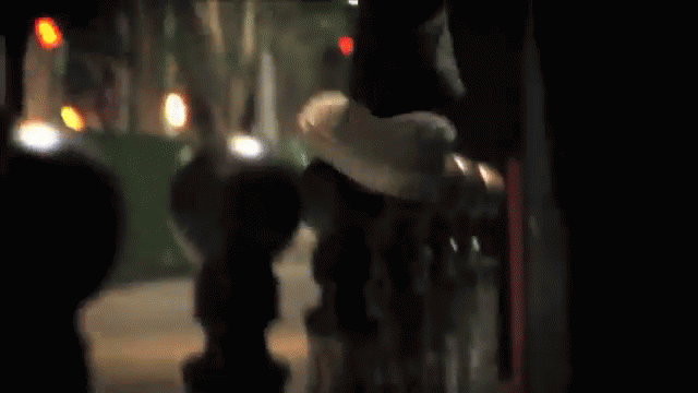A Skateboarder Is Doing A Trick In Front Of A Bridge GIF