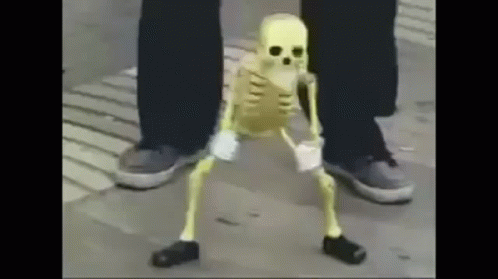 A Skeleton Is Dancing On The Sidewalk Next To A Person 'S Legs . GIF