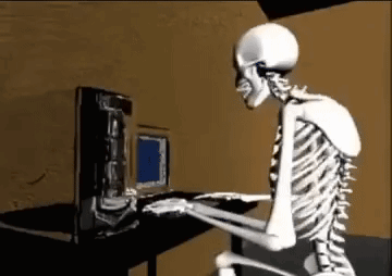 A Skeleton Is Sitting At A Desk Typing On A Computer . GIF
