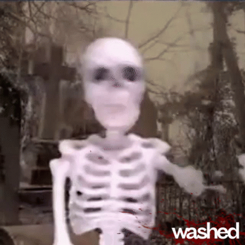 A Skeleton Is Standing In A Cemetery With The Word Washed On The Bottom Right GIF