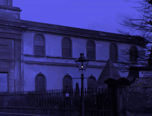 A Skeleton Is Standing In Front Of A Building That Says Maryland On It GIF