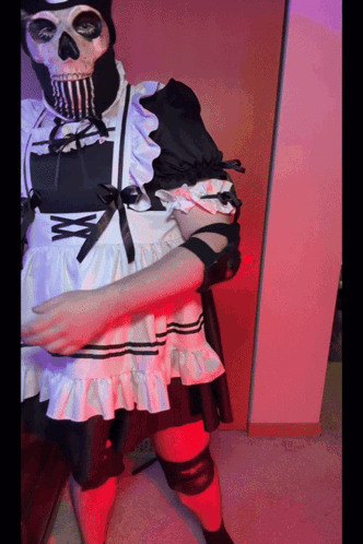 A Skeleton Wearing A Maid Costume With A Bow GIF