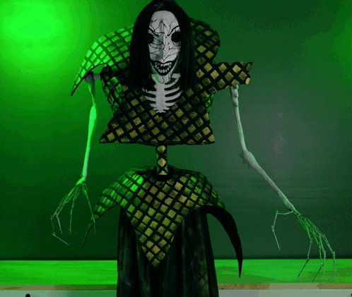 A Skeleton With Long Black Hair And Sharp Teeth Stands In Front Of A Green Wall GIF